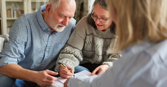 Older Couple Singing Papers